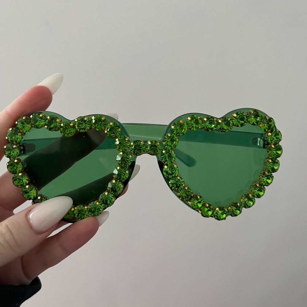 Women’s transparent green heart shaped rhinestone sunglasses.